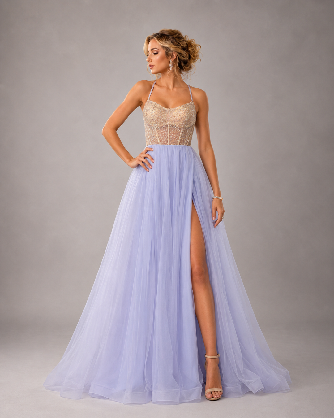 Lavender tulle A-line gown with beaded bodice, spaghetti straps, and high front slit for prom and formal occasions.