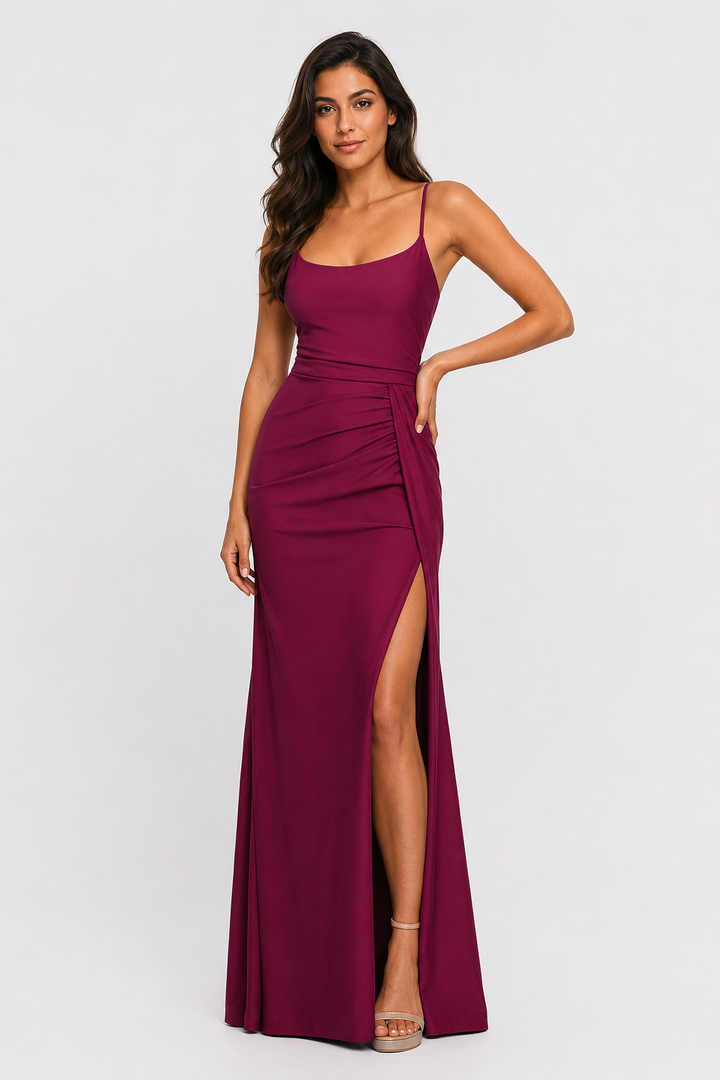 Burgundy ruched maxi dress with spaghetti straps, scoop neckline, and high side slit for prom and formal occasions.