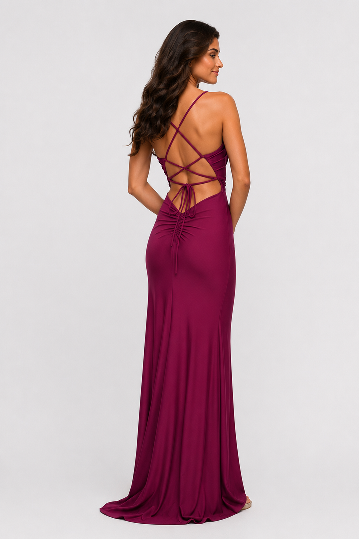 Burgundy ruched maxi dress with spaghetti straps, scoop neckline, and high side slit for prom and formal occasions.
